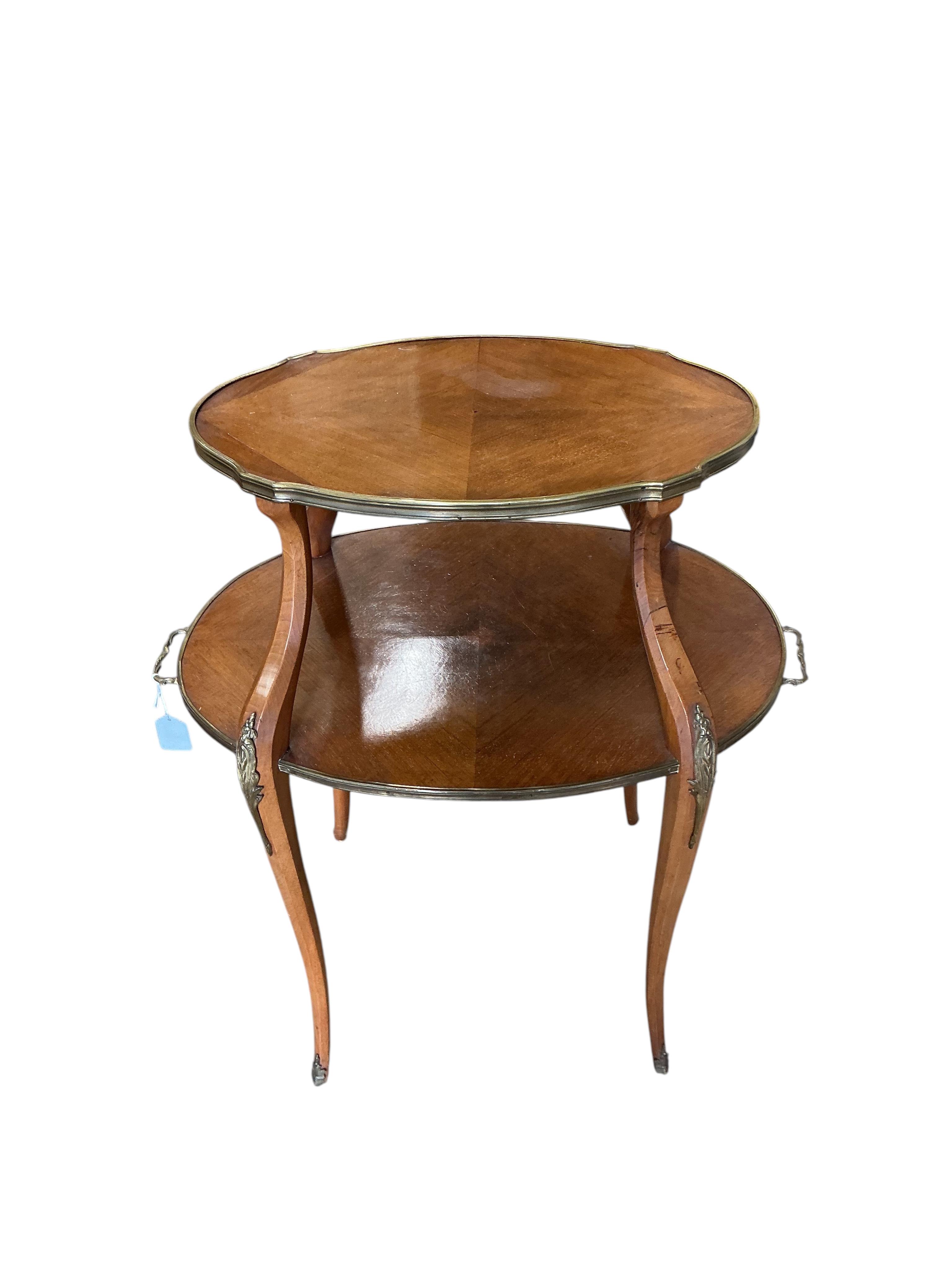 A gilt metal mounted oval mahogany two tier etagere, width 72cm, depth 46cm, height 88cm.